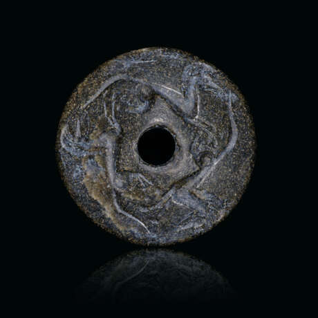 A GREEK BLACK STEATITE PERFORATED DISC WITH THREE HORSES - Foto 1