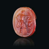 AN ETRUSCAN CARNELIAN SCARAB WITH A YOUTH HOLDING A HARE - фото 1