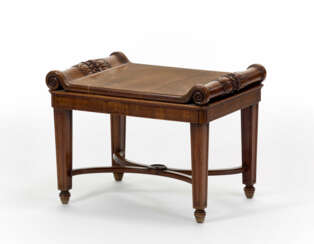 Solid carved wood stool, legs joined by curvilinear crosspieces joined by caster