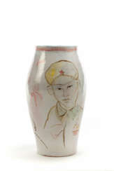 Large ceramic vase decorated with figures of Chinese soldier, woman, and child in shades of brown, green, red, and yellow on a white background under showcase