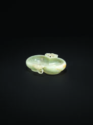 A WHITE AND RUSSET JADE DOUBLE GOURD-FORM &#39;TWIN BATS&#39; WASHER