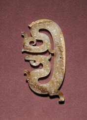 A RETICULATED JADE DRAGON-FORM PENDANT
