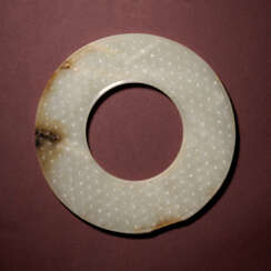 A WHITE AND RUSSET JADE RING, HUAN