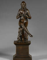 A BRONZE FIGURE OF A SEATED NUDE WOMAN BRAIDING HER HAIR