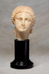 A GREEK MARBLE HEAD OF A GODDESS