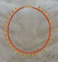 AN EGYPTIAN GOLD AND CARNELIAN BEAD NECKLACE WITH NEFER PENDANTS