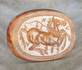 A GREEK BANDED CARNELIAN SCARABOID WITH A HORSE
