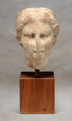 A GREEK MARBLE HEAD OF A GODDESS