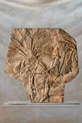 AN ASSYRIAN GYPSUM RELIEF FRAGMENT