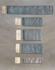 FIVE NEO-ASSYRIAN CHALCEDONY CYLINDER SEALS AND A LIMESTONE STAMP SEAL