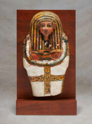 AN EGYPTIAN PAINTED LIMESTONE MODEL COFFIN LID