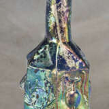 A ROMAN MOLD-BLOWN BLUE GLASS HEXAGONAL BOTTLE WITH DIONYSIAC SYMBOLS - photo 1