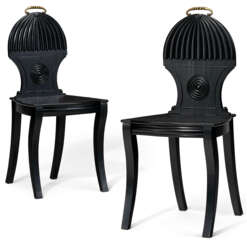 A PAIR OF REGENCY STYLE EBONIZED HALL CHAIRS