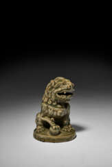 A MOLDED YAOZHOU CELADON FIGURE OF A LION