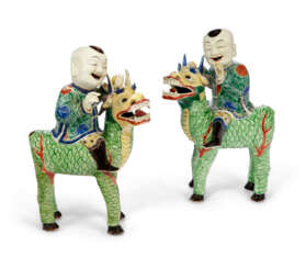 A PAIR OF FAMILLE VERTE FIGURES OF BOYS RIDING QILIN