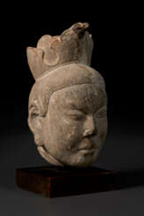 A STONE HEAD OF A DEITY