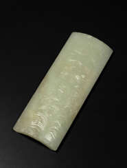 A CARVED PALE GREENISH-WHITE JADE WRIST REST