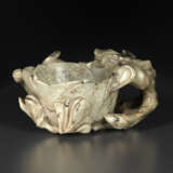 A MOTTLED GREYISH-BEIGE JADE `MAGNOLIA` CUP - photo 1