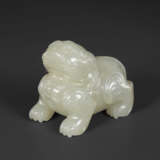 A SMALL PALE GREYISH-WHITE JADE FIGURE OF A MYTHICAL BEAST - photo 1