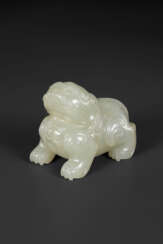 A SMALL PALE GREYISH-WHITE JADE FIGURE OF A MYTHICAL BEAST