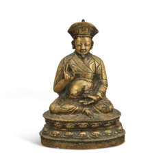 A RARE COPPER AND SILVER-INLAID BRONZE FIGURE OF NGAWANG DRAKPA (1520-1580)