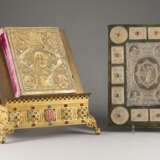 A BOOK OF GOSPELS ON A STAND AND A COVER OF A BOOK OF GO - photo 1