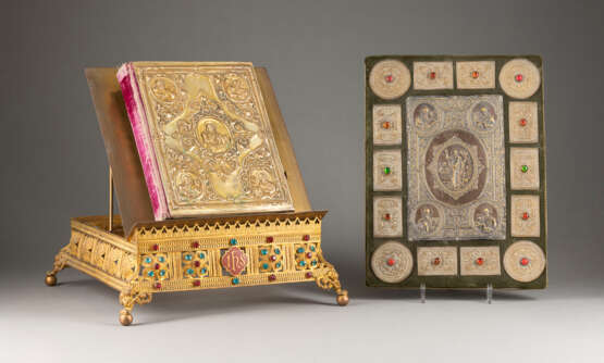 A BOOK OF GOSPELS ON A STAND AND A COVER OF A BOOK OF GO - photo 1