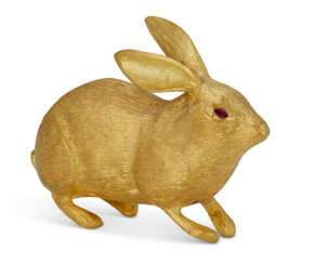 A RUBY-MOUNTED 24K GOLD FIGURE OF A RABBIT