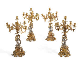 A SET OF FOUR NAPOLEON III GILT AND SILVERED-BRONZE SEVEN-LIGHT CANDELABRA