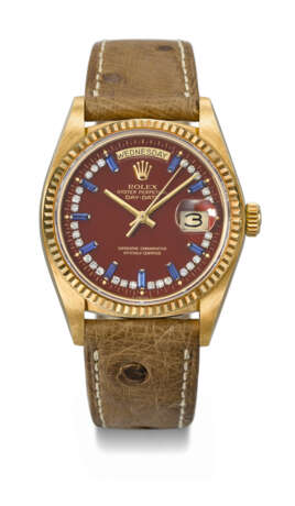 ROLEX. A RARE AND HIGHLY ATTRACTIVE 18K GOLD, DIAMOND AND SAPPHIRE-SET AUTOMATIC WRISTWATCH WITH SWEEP CENTRE SECONDS, DAY, DATE AND OXBLOOD LACQUERED `STELLA` DIAL - Foto 1