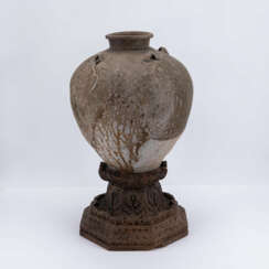 Bulbous vase on wooden base