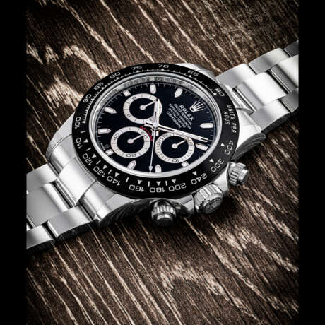 ROLEX. A STAINLESS STEEL AUTOMATIC CHRONOGRAPH WRISTWATCH WITH BRACELET AND BLACK DIAL - photo 1