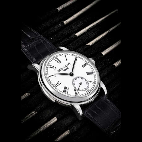 PATEK PHILIPPE. A RARE PLATINUM AUTOMATIC MINUTE REPEATING WRISTWATCH WITH WHITE ENAMEL DIAL - photo 1