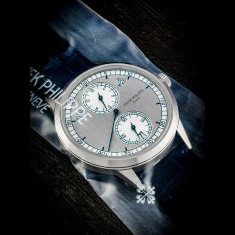 PATEK PHILIPPE. AN 18K WHITE GOLD AUTOMATIC ANNUAL CALENDAR WRISTWATCH WITH REGULATOR-STYLE DIAL, SINGLE SEALED - фото 1