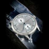 PATEK PHILIPPE. AN 18K WHITE GOLD AUTOMATIC ANNUAL CALENDAR WRISTWATCH WITH REGULATOR-STYLE DIAL, SINGLE SEALED - photo 1