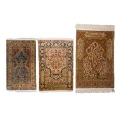 3 Oriental silk carpets. HEREKE, 20th c.,