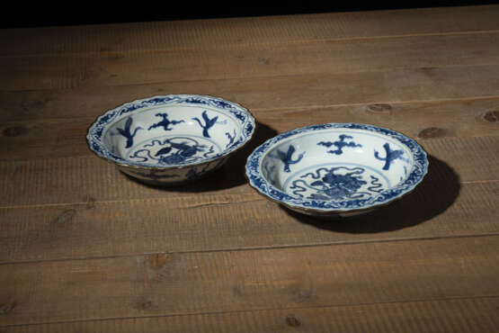 Zwei blütenförmige Teller aus Porzellan mit unterglasurblauem Dekor mythischer Kreaturen und Metallmontierung - Foto 1