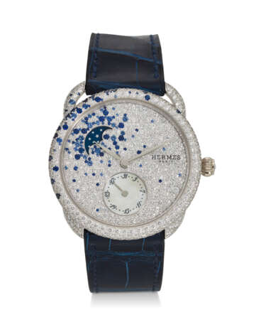 HERMÈS, REF. AR7.A93, ARCEAU PETITE LUNE, A FINE 18K WHITE GOLD, MOTHER-OF-PEARL, DIAMOND, AND SAPPHIRE-SET WRISTWATCH WITH DATE AND MOON PHASES - photo 1