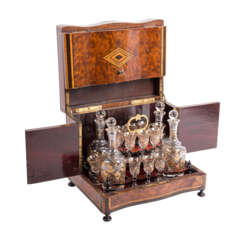 Tantalus with 15 liqueur glasses and 4 decanters, around 1890.
