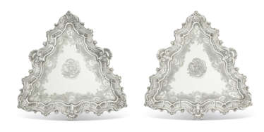 A PAIR OF GEORGE II SILVER SALVERS OR KETTLE STANDS