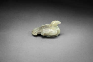 A VERY RARE AND IMPORTANT PALE GREENISH-WHITE AND GREY JADE FIGURE OF A RECUMBENT BIRD