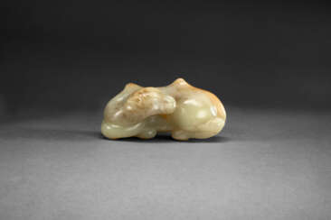 A FINELY CARVED YELLOW AND RUSSET JADE FIGURE OF A RECUMBENT BACTRIAN CAMEL
