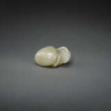 AN UNUSUAL INSCRIBED PALE YELLOWISH-GREEN JADE CARVING OF A RAM EMERGING FROM A PEBBLE - фото 1