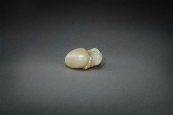 AN UNUSUAL INSCRIBED PALE YELLOWISH-GREEN JADE CARVING OF A RAM EMERGING FROM A PEBBLE - Foto 1