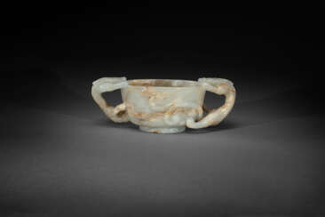 A PALE GREENISH-WHITE AND RUSSET JADE CUP WITH &#39;CHILONG&#39; HANDLES