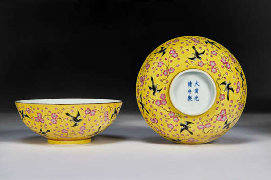 A PAIR OF FAMILLE ROSE YELLOW-GROUND `MAGPIE AND PLUM BLOSSOM` BOWLS - photo 1