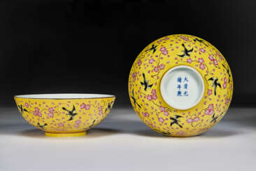 A PAIR OF FAMILLE ROSE YELLOW-GROUND &#39;MAGPIE AND PLUM BLOSSOM&#39; BOWLS