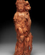 Coral. A RARE LARGE AND FINELY CARVED CORAL FIGURE OF GUANYIN