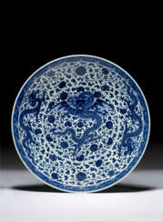A LARGE AND RARE BLUE AND WHITE &#39;WINGED-DRAGON&#39; DISH