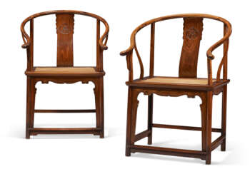A RARE PAIR OF HUANGHUALI HORSESHOE-BACK ARMCHAIRS